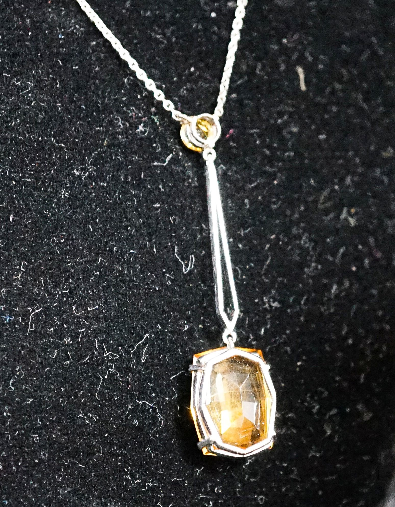 A white metal and two stone citrine set drop line pendant necklace, pendant 45mm, chain 40cm, gross weight 4.1 grams.